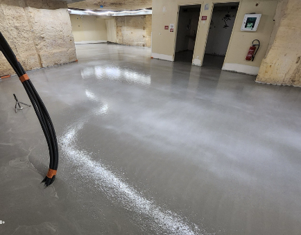 Sol en béton fraîchement coulé dans un sous-sol.