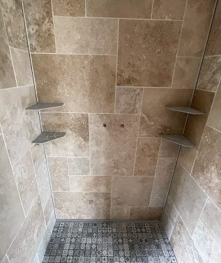 Douche moderne avec carrelage beige.